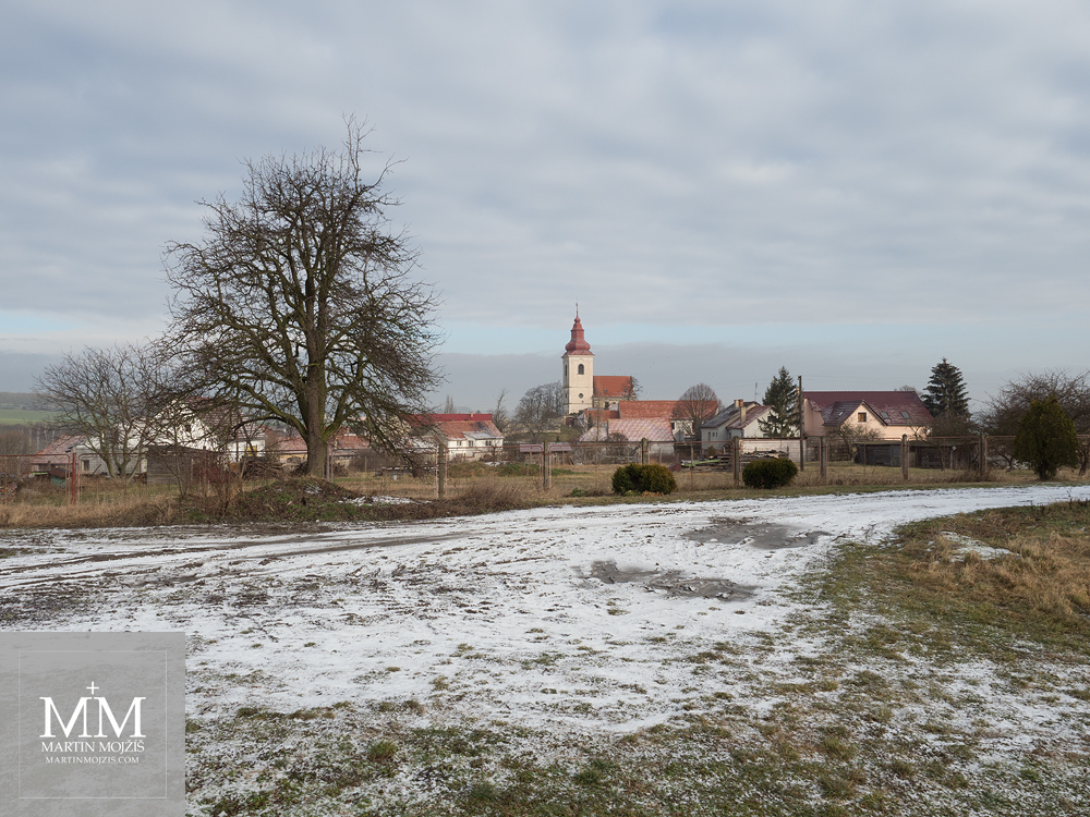 Village in winter, baroque church in the background. Photograph created with Olympus 12 - 40 mm 2.8 Pro lens.